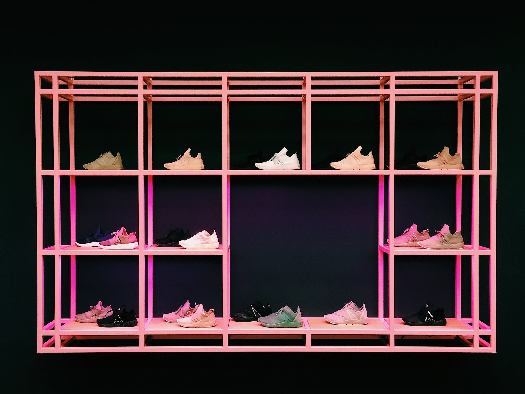pink shoe rack with assorted color and style shoes