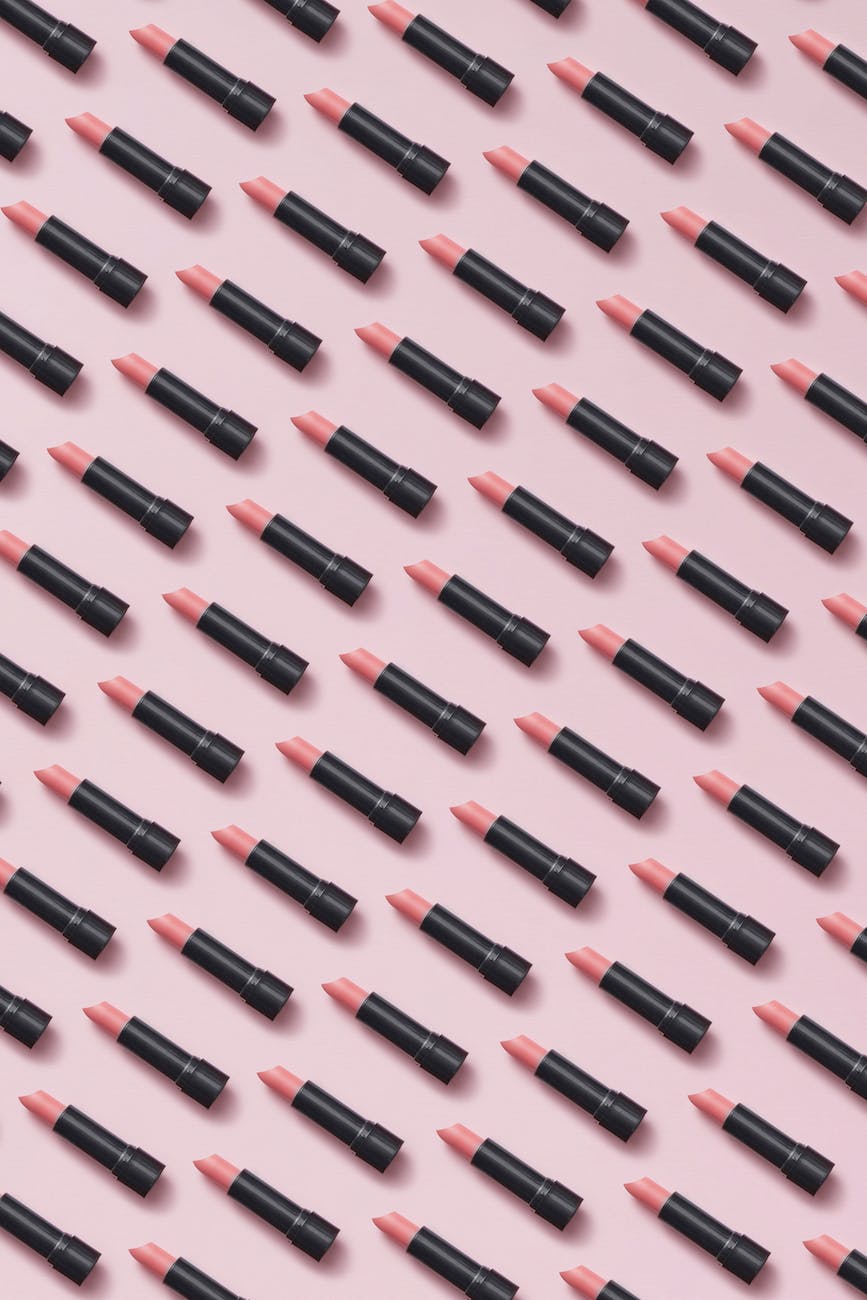 arranged lipsticks on pink surface